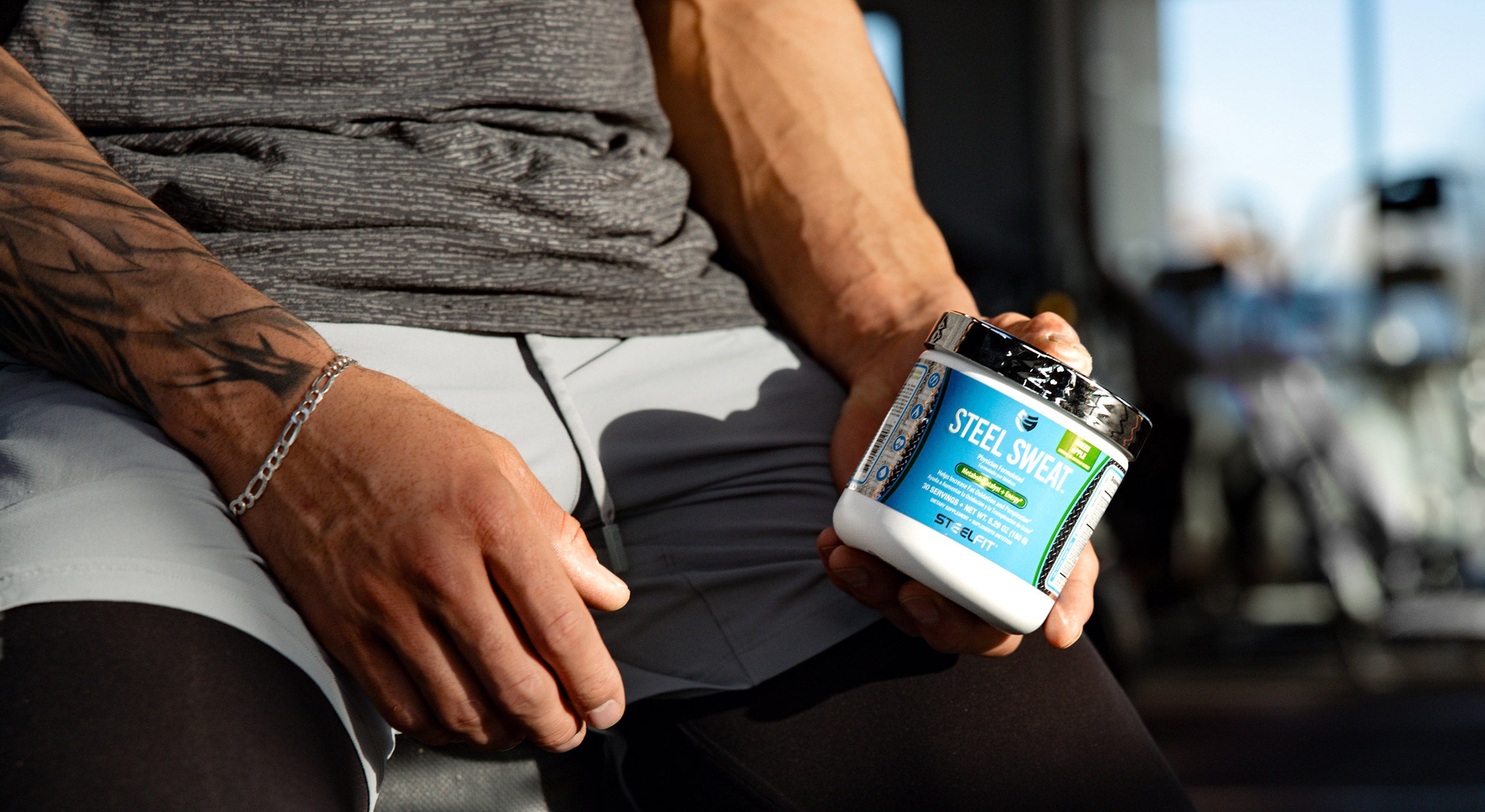 healthy fitness woman holding SteelFit supplements, weight loss, healthy lifestyle, build muscle