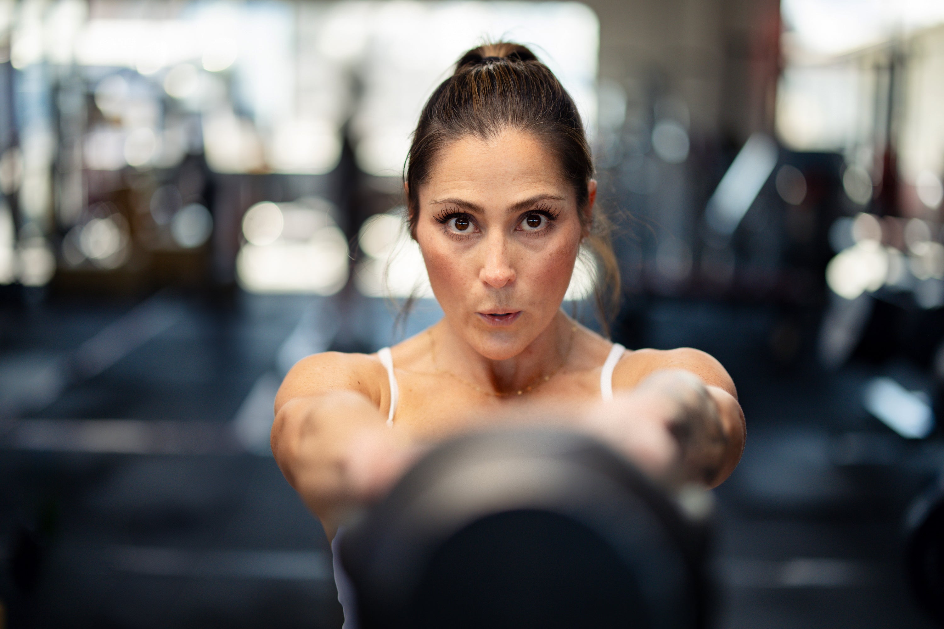 Fit woman swinging kettle bell