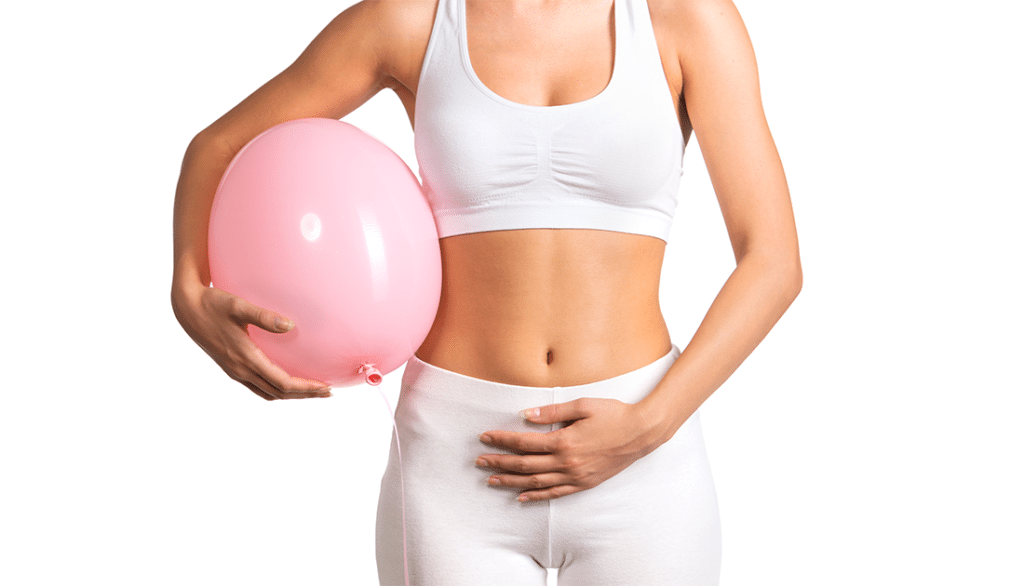 A woman in white sports attire holds a pink balloon, symbolizing fitness and lifestyle associated with SteelFit USA's health and fitness goals.