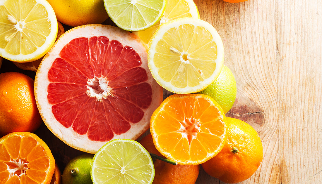 A close-up image of various citrus fruits, including oranges and lemons, highlighting their vibrant colors and textures.