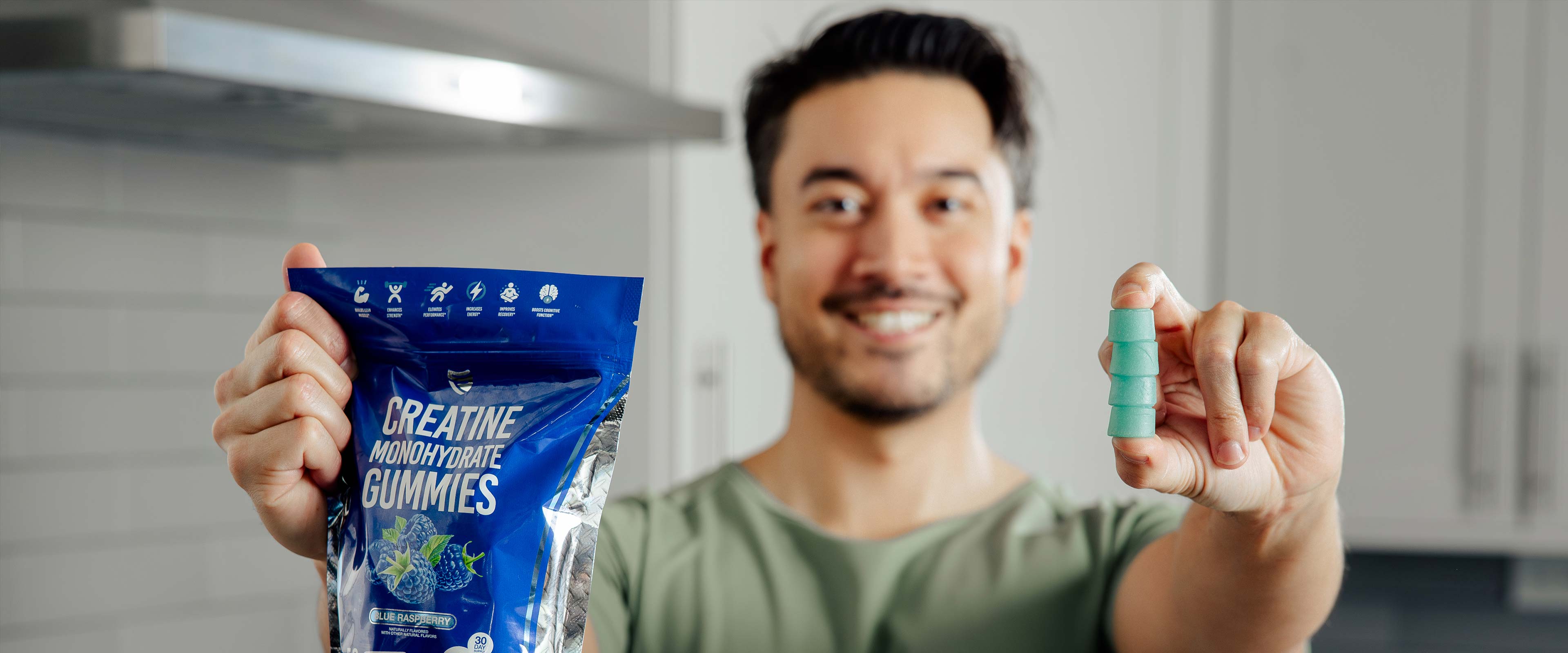 Happy male holding SteelFit Creatine Monohydrate Gummies