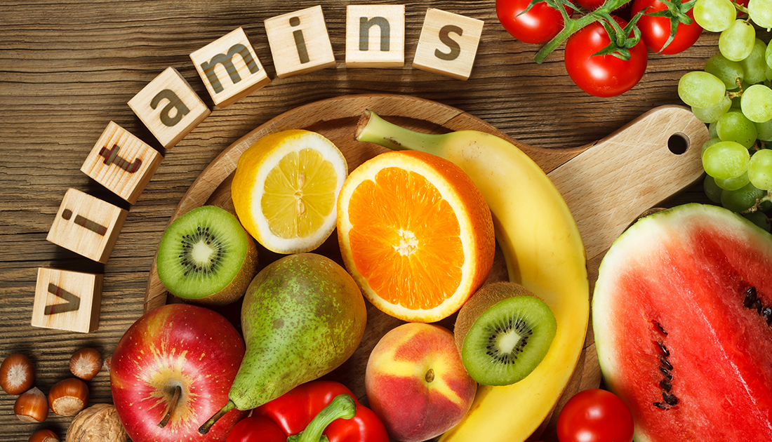 A plate of assorted fruits and vegetables, including an orange, lemon, watermelon, and tomato, symbolizing natural and nutritious dietary choices.