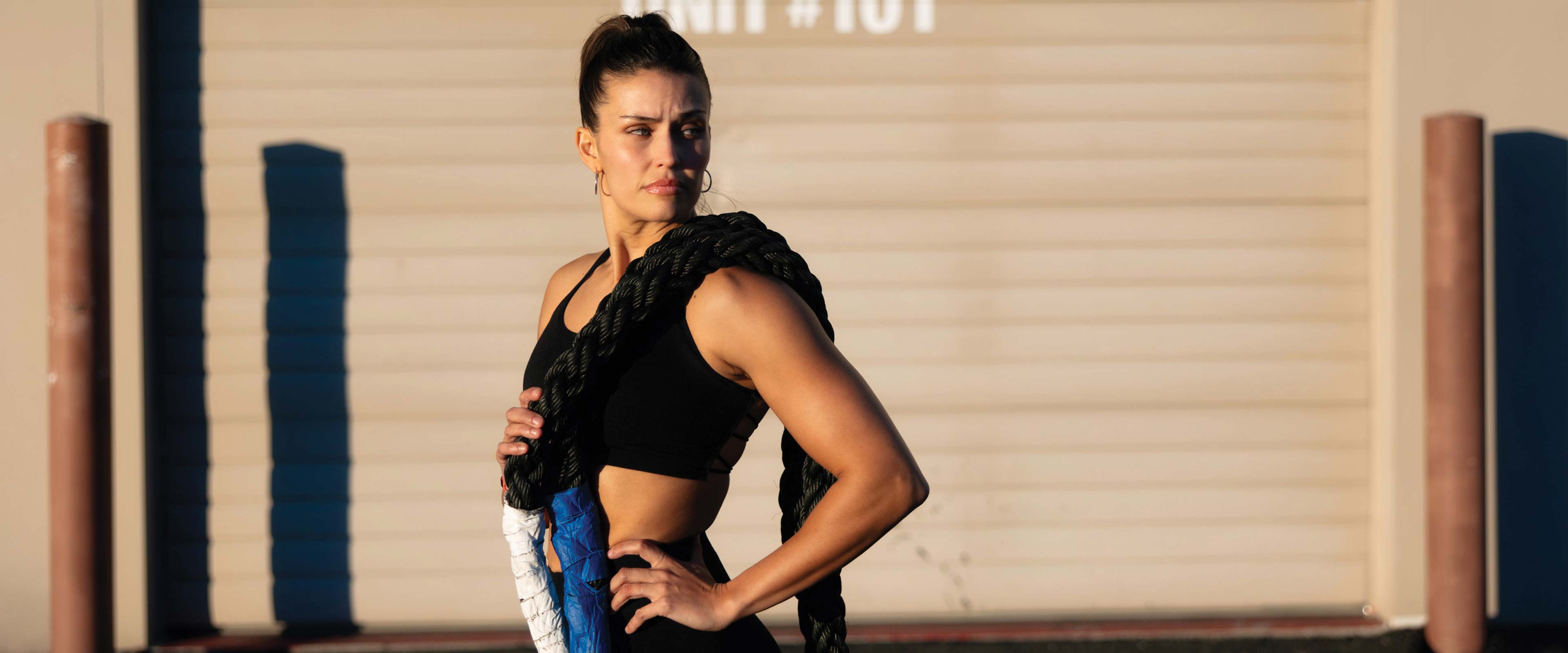 Woman outside gym with battle ropes