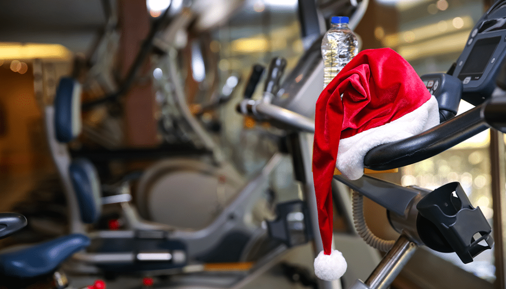 A santa claus hat resting on a treadmill to promote SteelFit's Holiday Weight Loss Workouts
