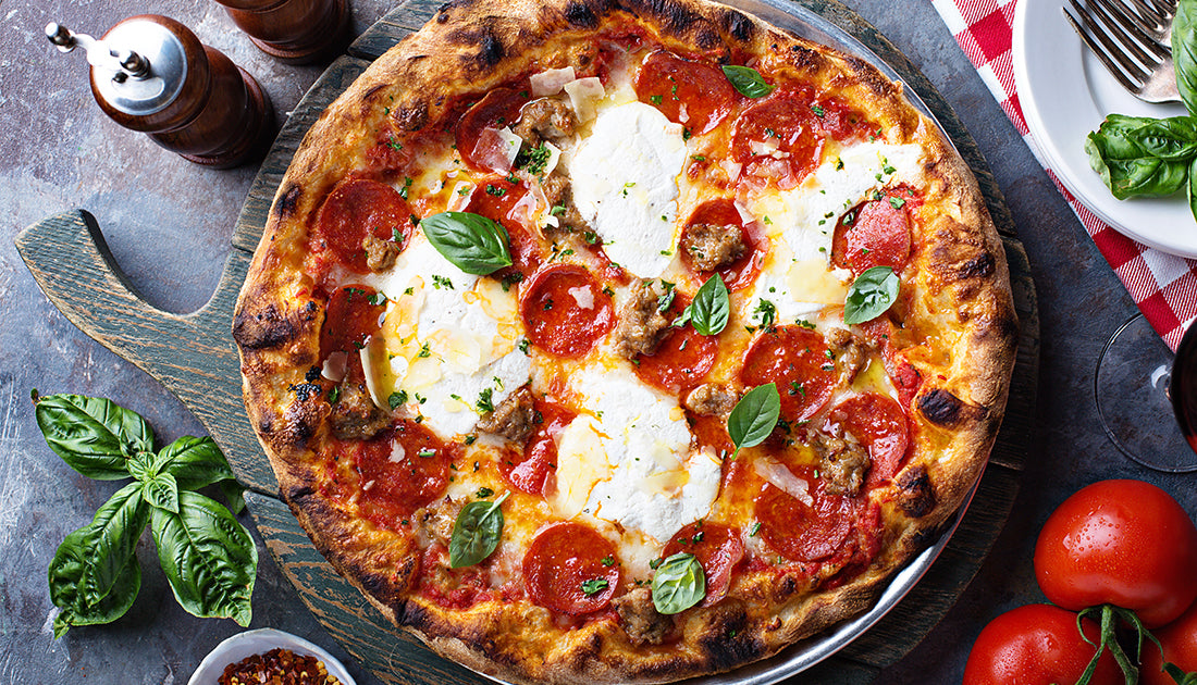 Close-up of a pepperoni and cheese pizza on a plate, emphasizing the delicious appeal of this classic Italian dish.