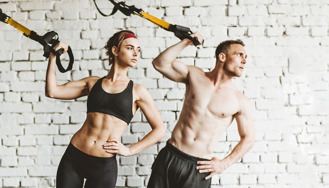 A man shirtless and a woman in black sportswear holding a strap, showcasing fitness and strength, aligning with SteelFit USA's health goals.