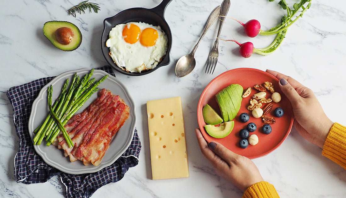 A breakfast plate featuring bacon, asparagus, and eggs, highlighting a balanced meal for fitness enthusiasts.