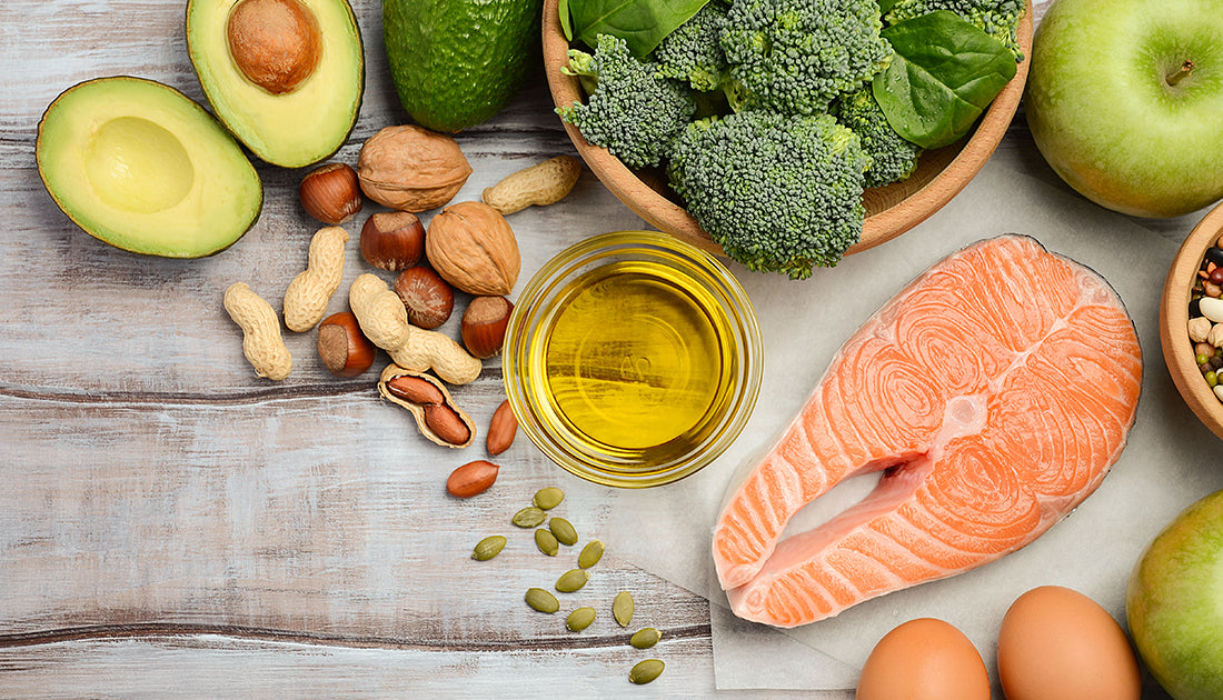 A healthy meal featuring salmon, broccoli, eggs, and a green apple, representing balanced nutrition, aligning with SteelFit USA's health and fitness goals.