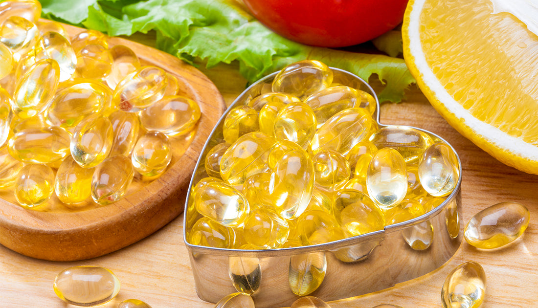 Heart-shaped container with yellow pills, accompanied by a close-up of a lemon, representing sports nutrition supplements from SteelFit USA.