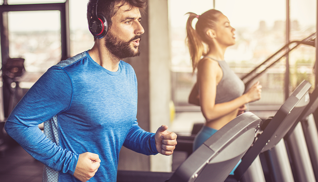 A man and woman running on treadmills at a gym, showcasing fitness and endurance, related to SteelFit USA's health and fitness products.