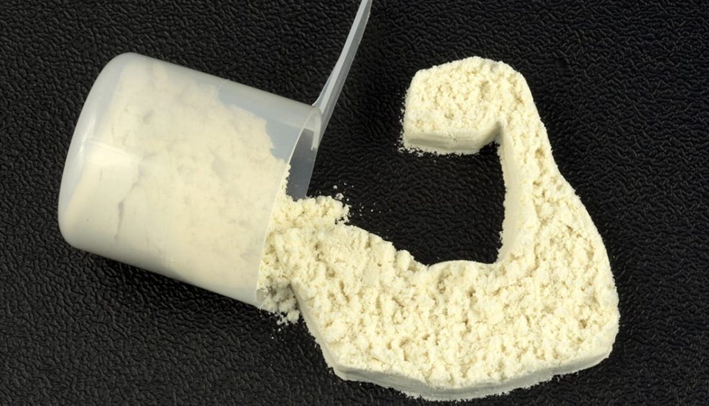 SteelFit Whey protein protein pouring out a scooper into a muscle arm shape