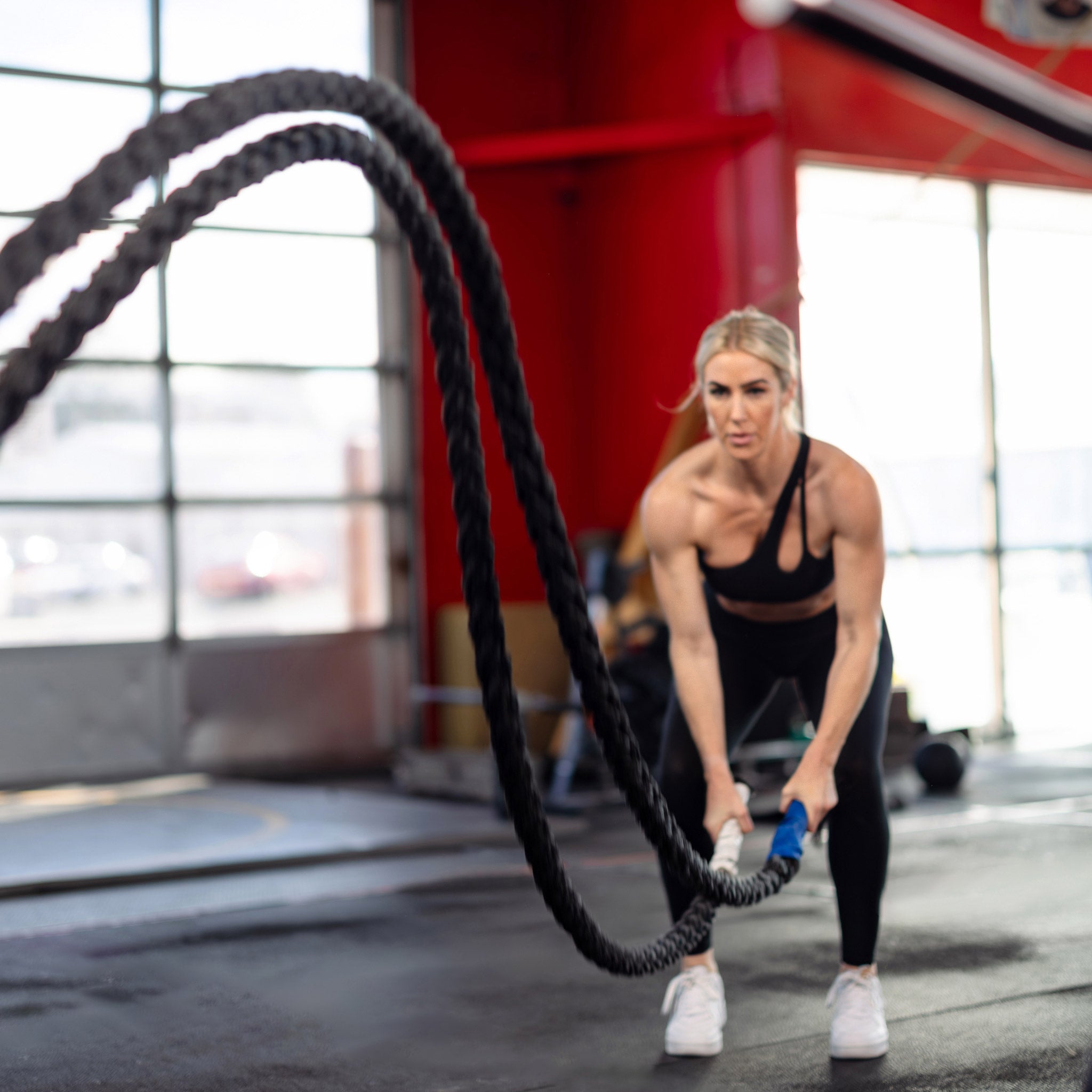 Female doing cardio with battle ropes