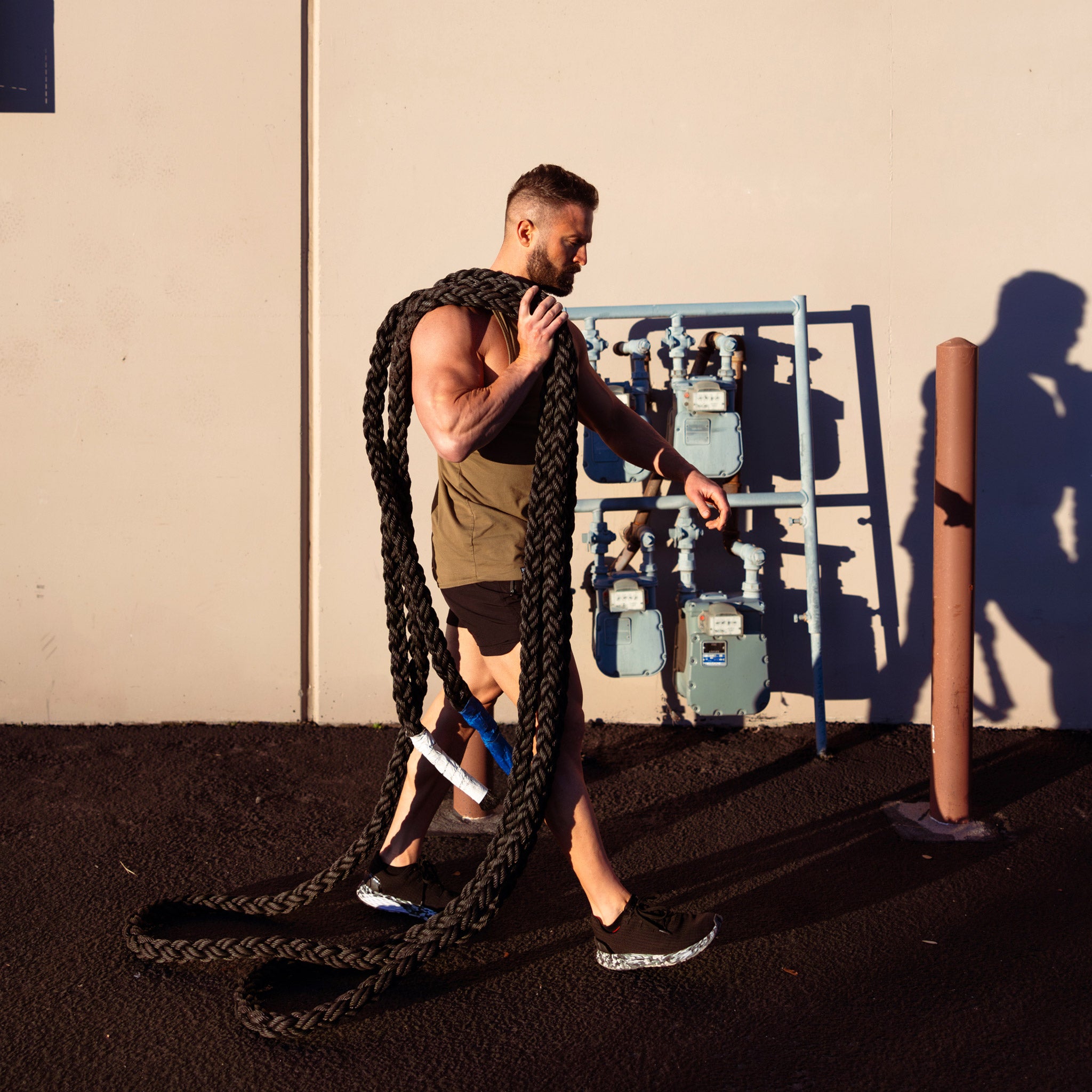 Fit male battle ropes