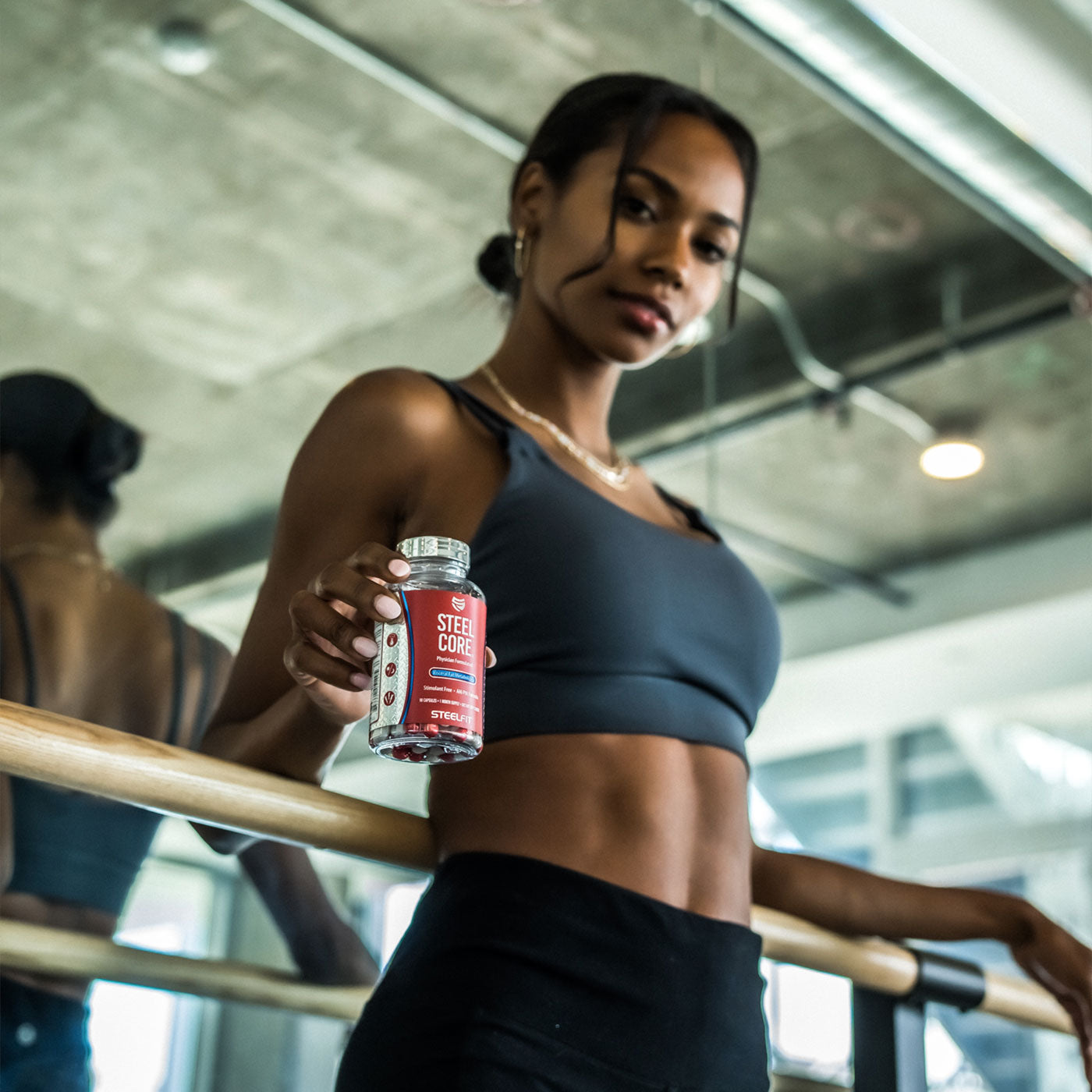 Attractive woman in shape showing abs with Steel Core from SteelFit