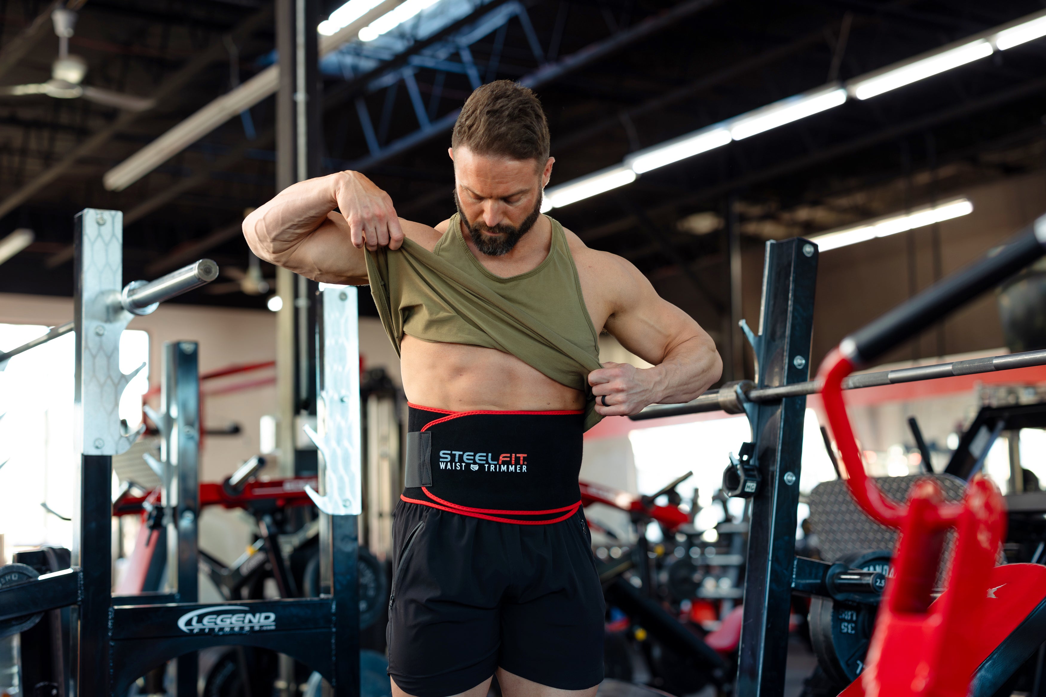 Fit man showing waist trimmer